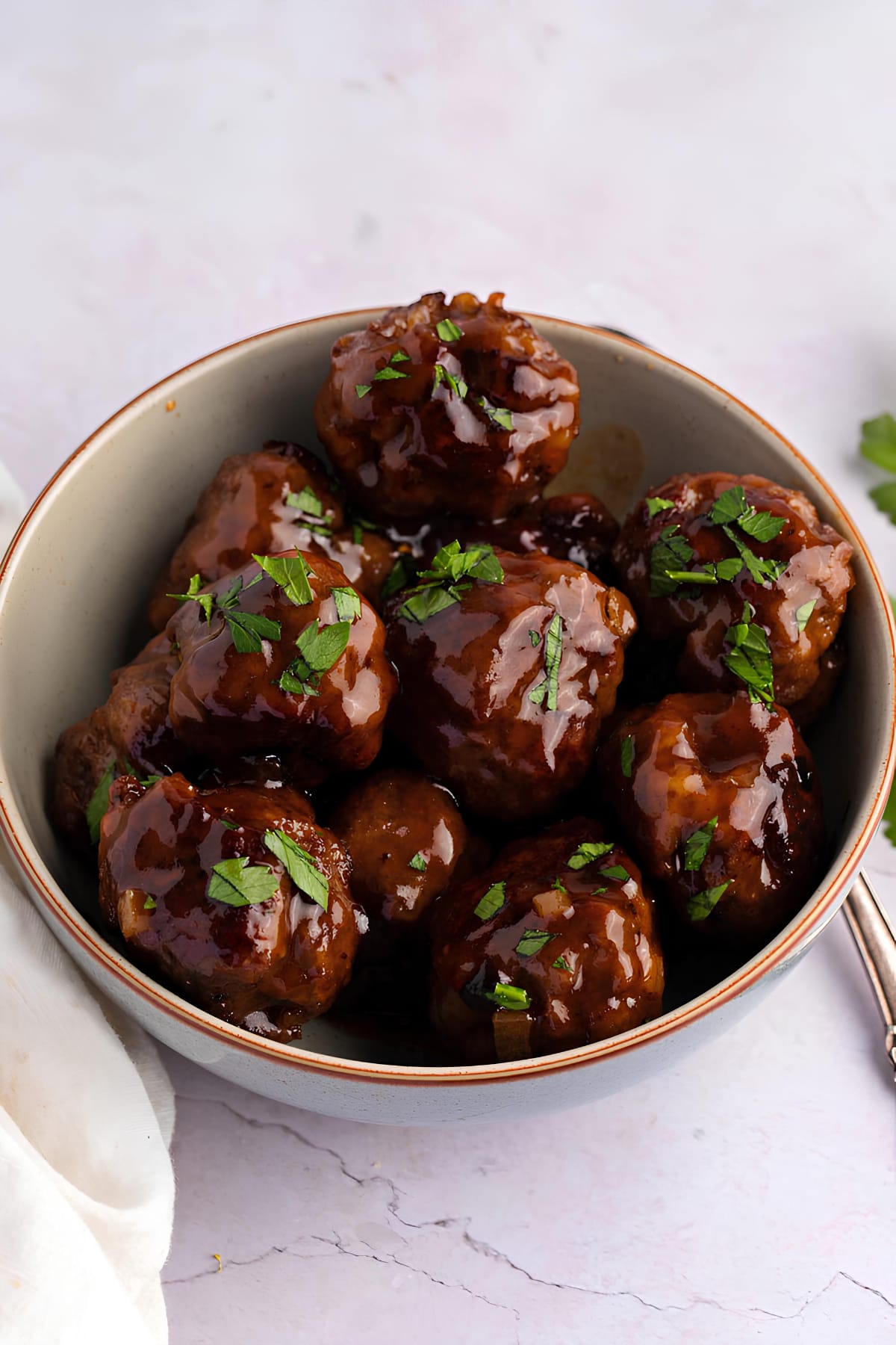 A Bowl of Sweet and Sour Meatballs Covered with Sauce