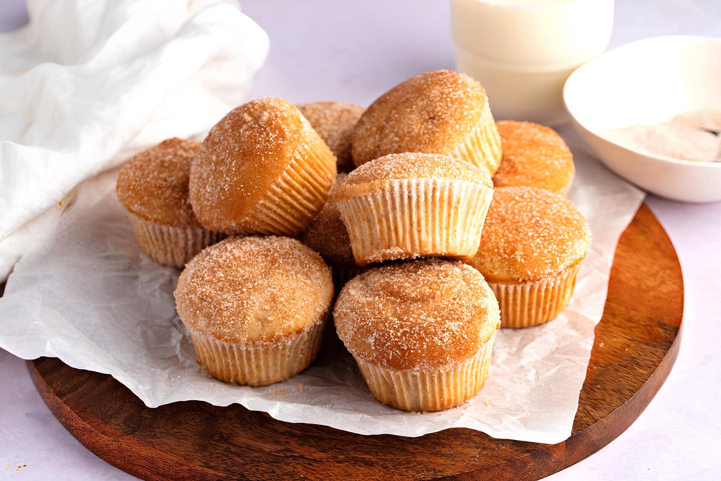 A Pile of Muffins on a Table Served with Milk