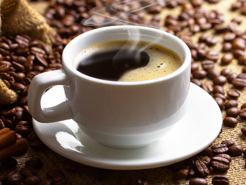 A Cup of Coffee and Coffee Beans on a Burlap