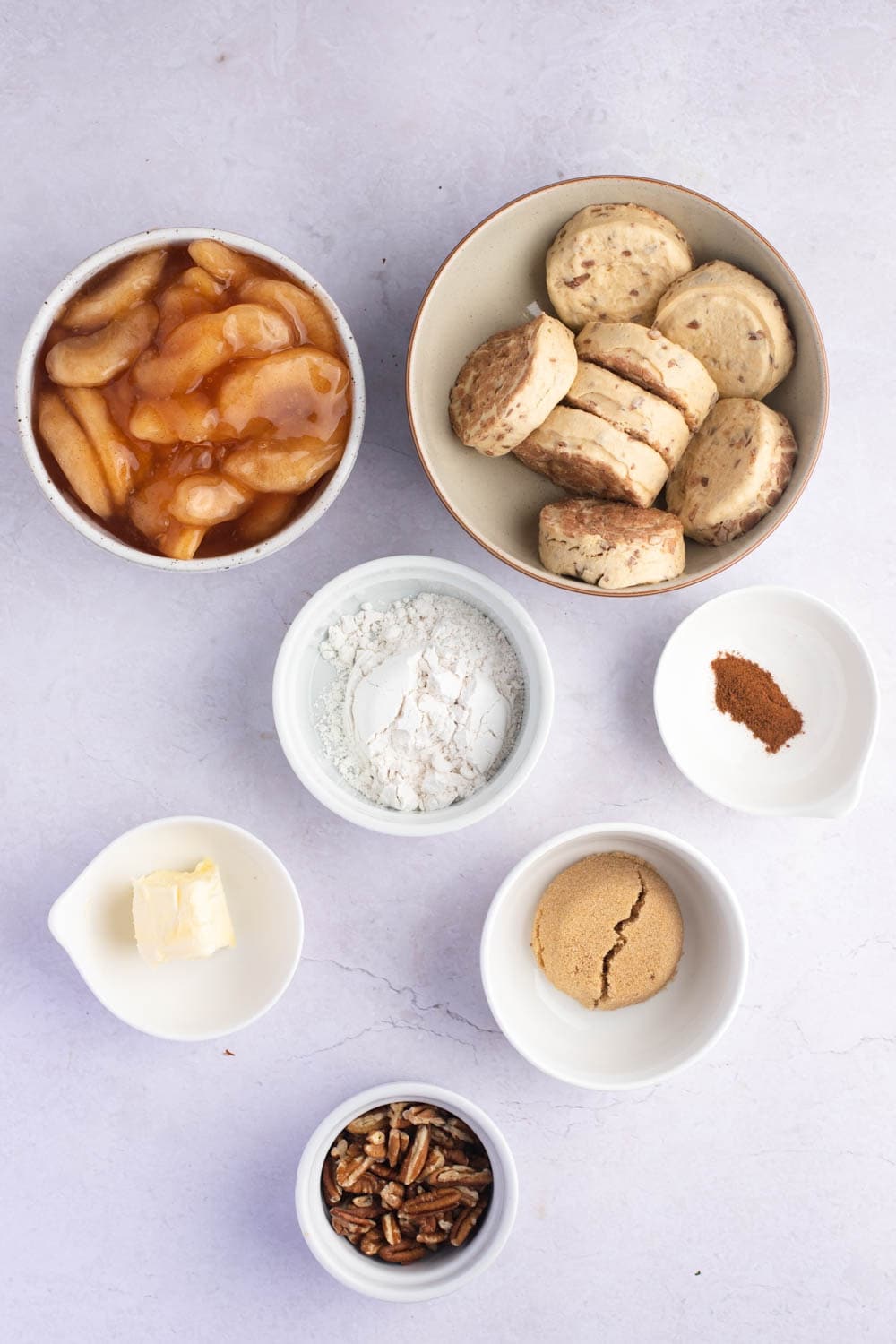 Cinnamon Roll Dutch Apple Pie Ingredients - Cinnamon Rolls, Canned Apple Pie Filling, Flour, Brown Sugar, Ground Cinnamon and Cold Butter