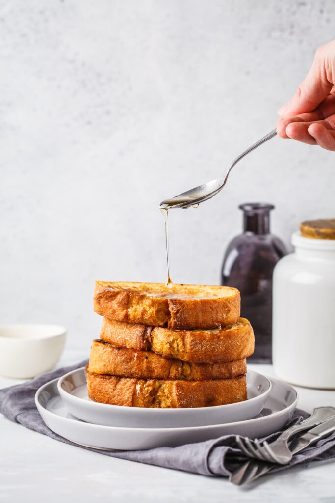 Denny's French Toast served on a plate with syrup drizzling over the top
