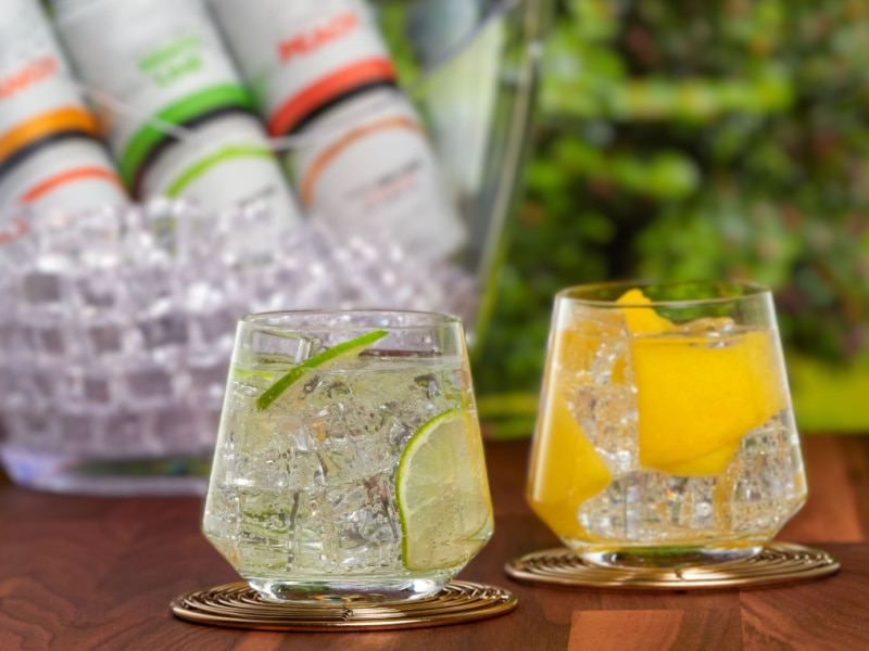 Two Glasses of Flavored Seltzers on a Wooden Table