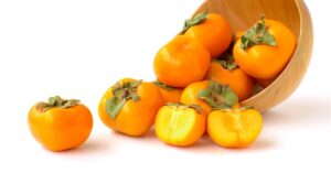 Fresh Organic Orange Persimmons on a White Background