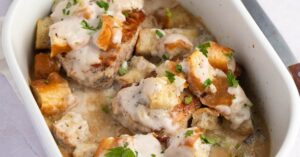 Homemade Baked Stuffed Pork Chops with Celery and Onions in a White Casserole