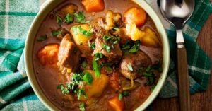 Homemade Beef Stew with Carrots, Potatoes and Herbs in a Bowl