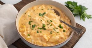 Homemade Buffalo Chicken Soup in a Bowl with Herbs