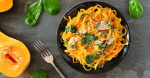 Homemade Butternut Squash Noodles with Spinach and Mushroom in a Black Plate