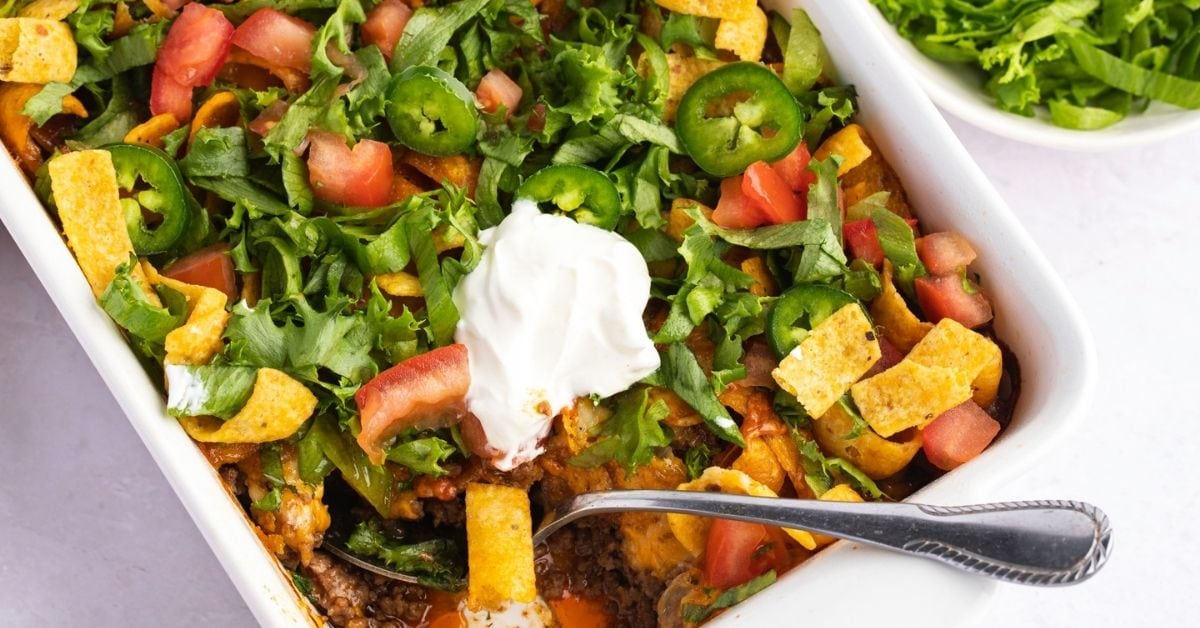 Homemade Taco Casserole with Tomatoes, Ground Beef, Frito Chips and Whipped Cream