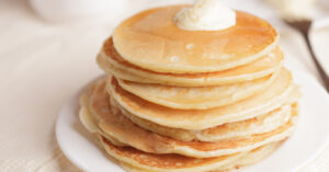 Jiffy Cornbread Pancakes Topped With Butter and Syrup