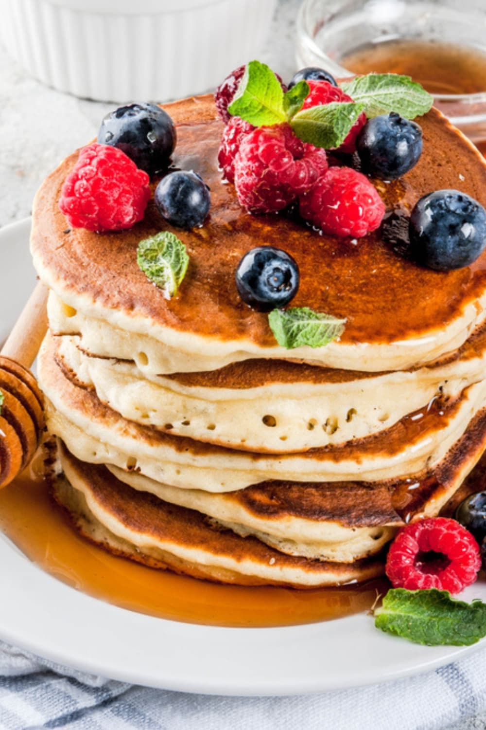 Closeup Oat Flour Pancakes Topped With Fresh Berries, Mint, and Honey