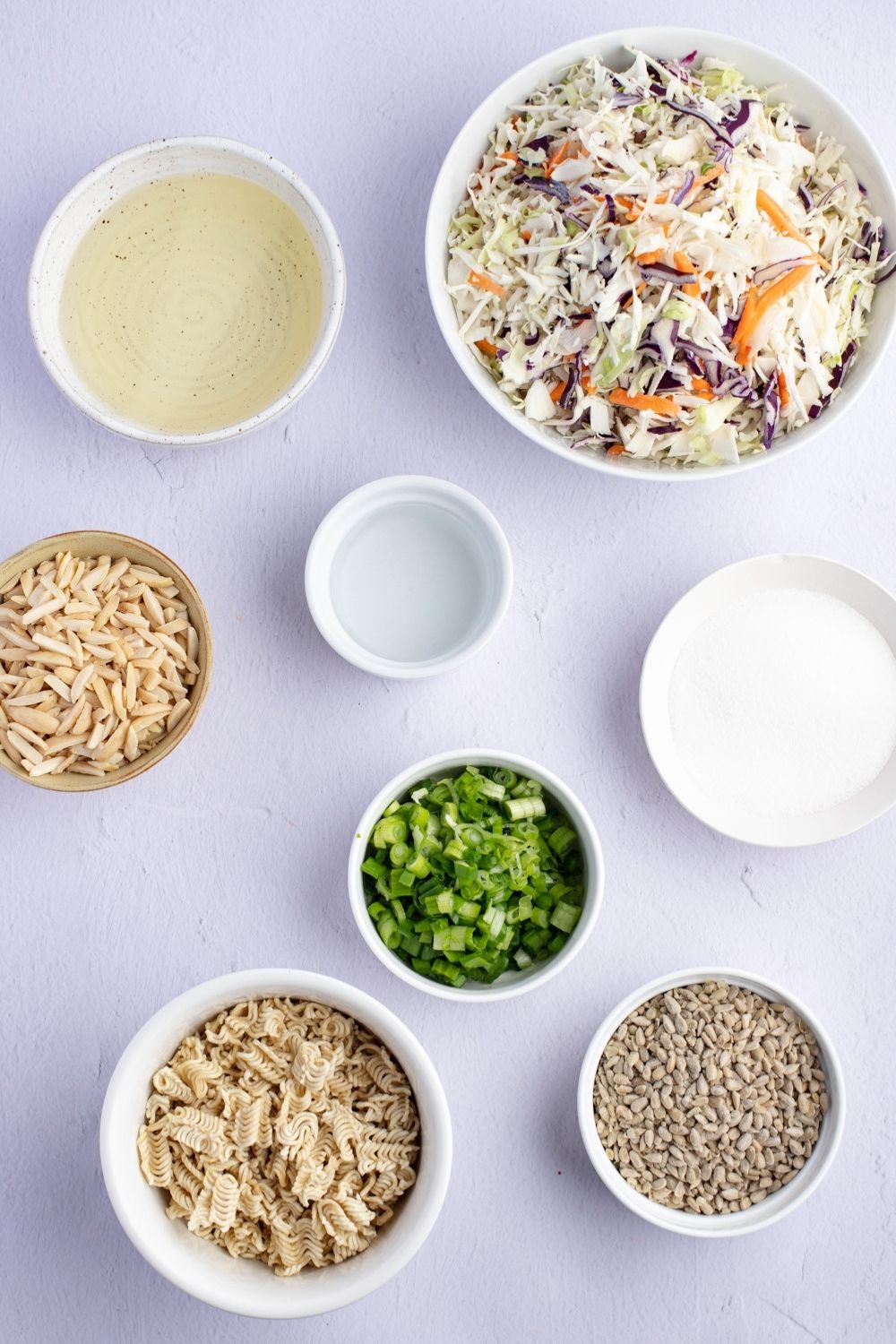 Oriental Coleslaw Ingredients: Coleslaw Mix, Green Onions, Almonds, Vinegar, Sugar, Noodles, Ramen Seasonings and Oil