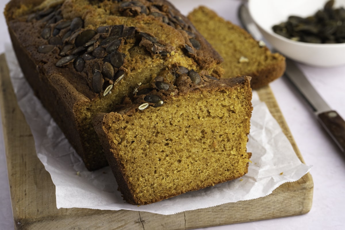 Copycat Starbucks Pumpkin Loaf with Pumpkin Seeds on a chopping board