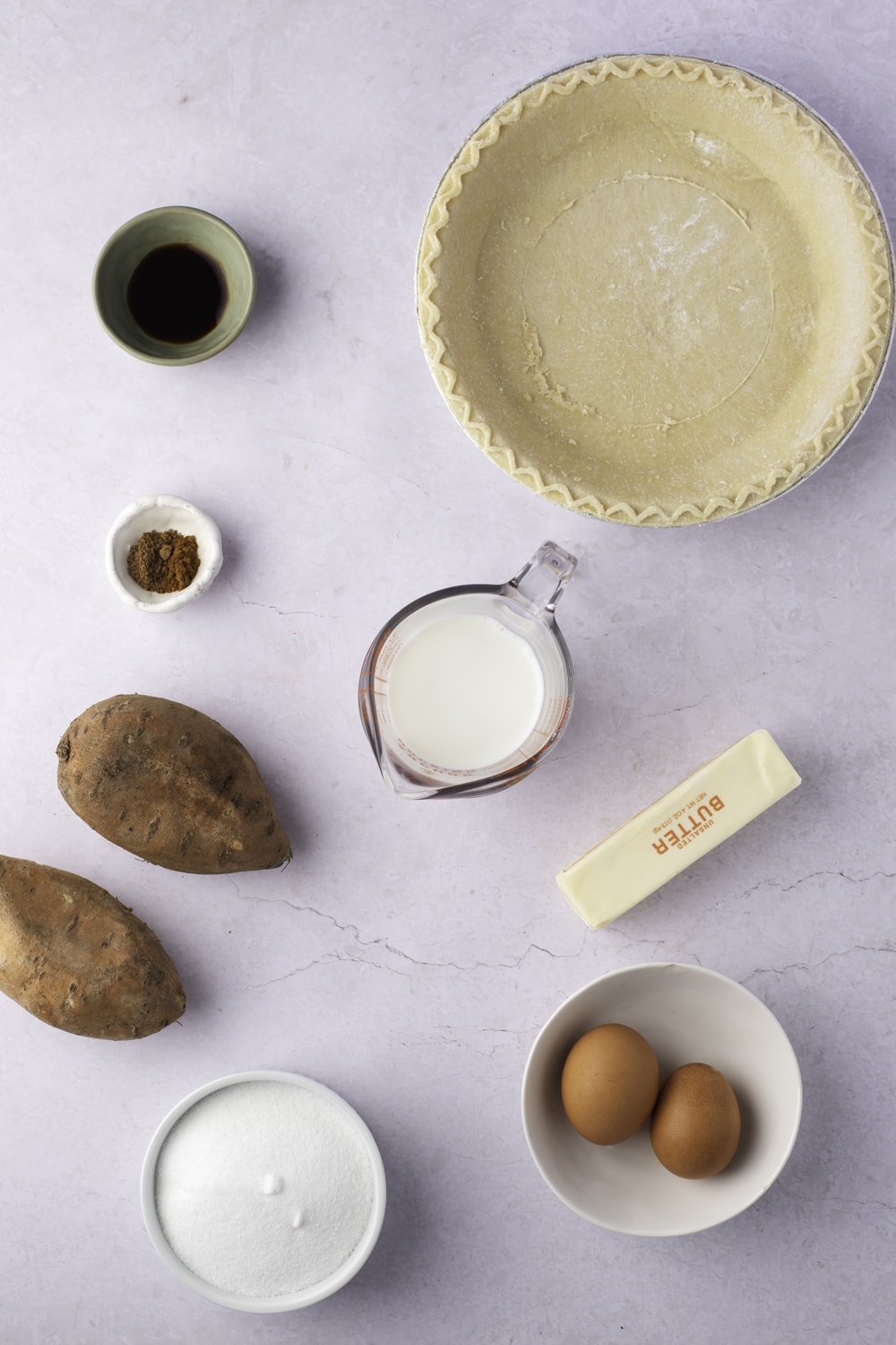 Sweet Potato Pie Ingredients: sweet potatoes, butter, sugar, milk, eggs, spices, vanilla, and a pie crust