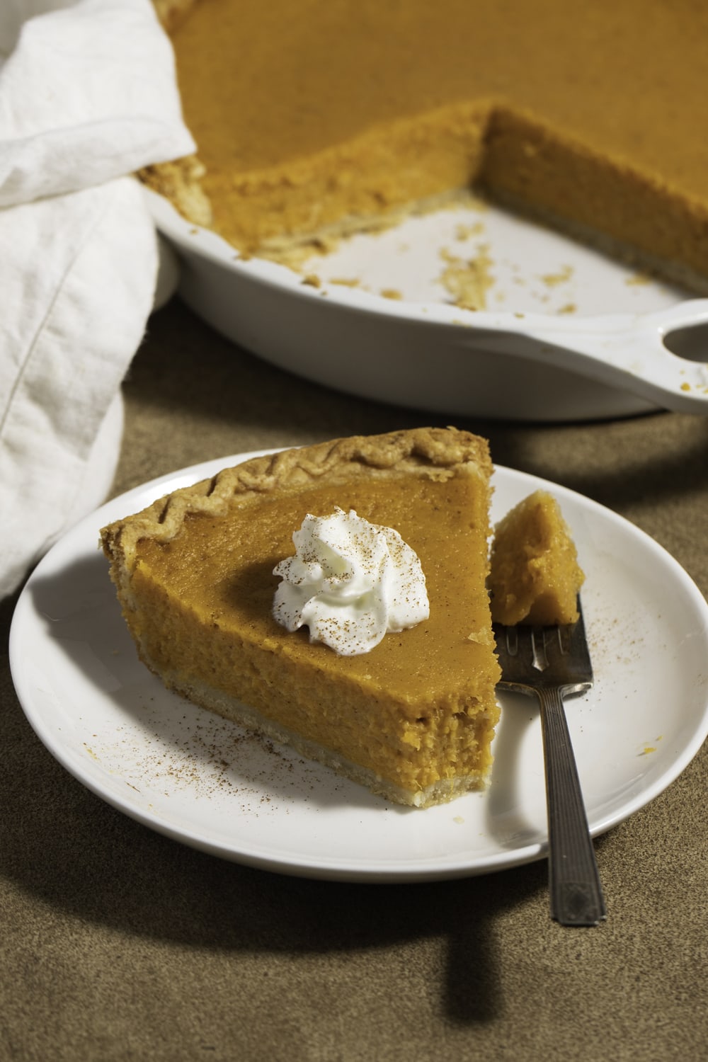 Sweet Potato Pie slice on a plate with whipped cream