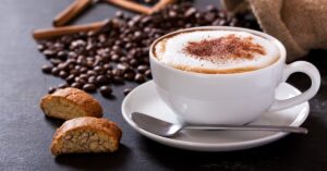 Warm Cappuccino on a White Cup with Bread